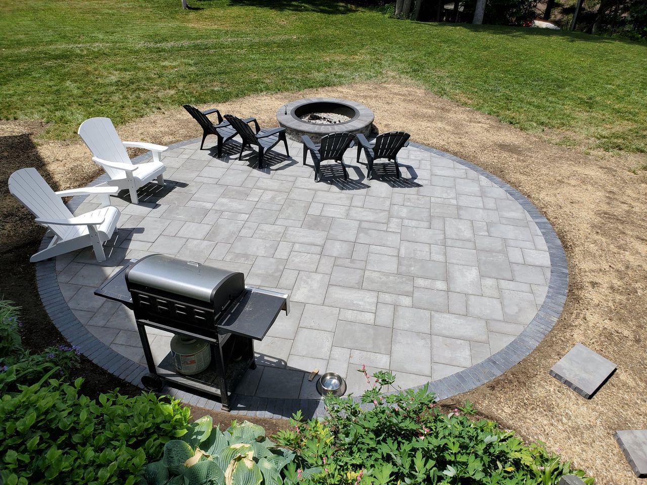 round Unilock patio in Shrewsbury Ma by Ideal Landscaping