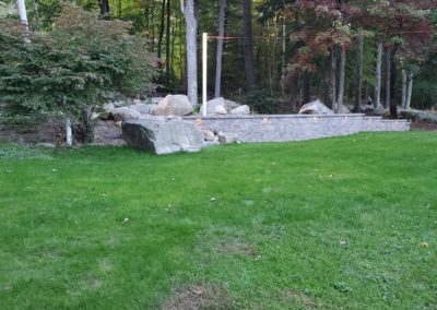 Unilock retaining wall and stairs in Jefferson MA by Ideal Landscape