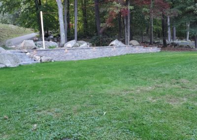 Unilock retaining wall and stairs in Jefferson MA by Ideal Landscape