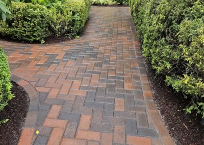A walkway in Holden with Ideal Block Boston Colonial Pavers built by Ideal Landscape