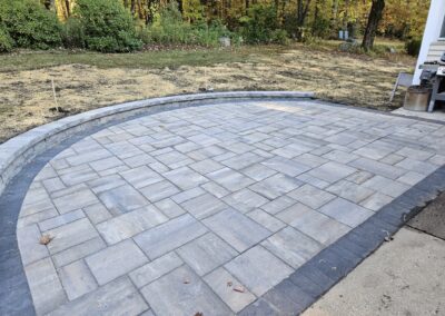 half round patio with seating wall in Holden MA by Ideal Landscape